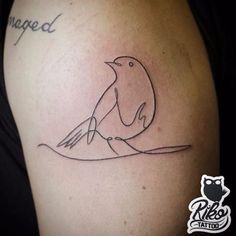 a tattoo with a bird sitting on top of it's arm and the word changed written in cursive writing