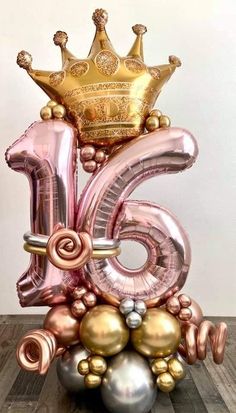 the number six is made out of balloons and has a crown on top of it