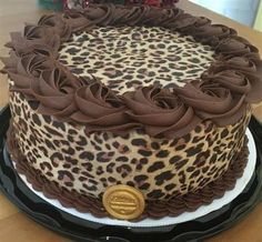 a leopard print cake sitting on top of a table