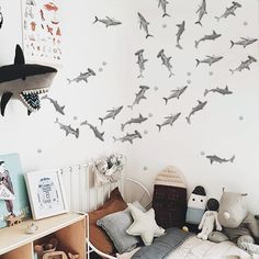 a child's bedroom with shark decals on the wall