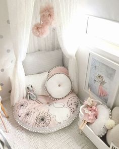 a baby's room is decorated in pink and white