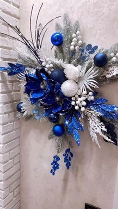 a blue and white christmas decoration hanging on the wall