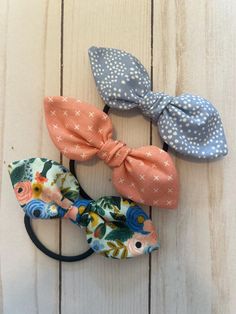 Set of 3 bow hair ties to dress up a ponytail or top knot bun. This set includes a couple Rifle Paper prints with gorgeous greens and blues and mustard yellow floral print as well. These are all 100% cotton material prints. These are perfect for adults, teens and girls!  All of my hair bows are handmade using quality materials. The fabric bow is attached to a thick black elastic band. The bow measures approximately 4 3/4 inches across.  I have other accessories to check out in my shop:  Theshinestand.etsy.com Shipping is calculated and combined at checkout if ordering more than one item. Shipping is always free on orders over $35. Fabric Hair Bow, Top Knot Bun, Knot Bun, Fabric Hair Bows, Coral Print, Paper Floral, Fabric Bows, Bow Set, Elastic Hair Bands