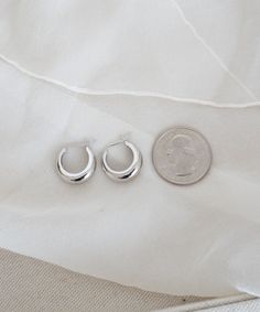 This smaller sister version of the Medium Crescent Hoop Earrings is perfect for daily wear. They're bold enough to make a statement while staying understated enough to match any outfit. Wear them alone or as the star of your ear stack; they look great no matter what you wear. Trendy Nickel-free Cartilage Earrings, Trendy Nickel-free Cartilage Earrings For Everyday, Trendy Small Hoop Sterling Silver Huggie Earrings, Trendy Small Hoop Huggie Earrings In Sterling Silver, Trendy Small Hoop Hypoallergenic Earrings, Trendy Sterling Silver Small Hoop Huggie Earrings, Trendy Everyday Hoop Cartilage Earrings, Trendy Hypoallergenic Small Hoop Earrings, Trendy Nickel-free Small Hoop Cartilage Earrings