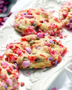 valentine's day cookies with sprinkles on a white plate