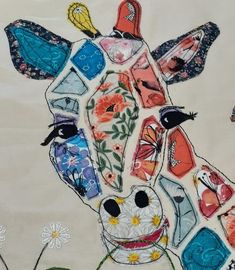 a painting of a giraffe with flowers and butterflies on it's face