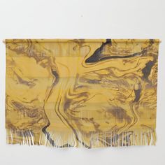 a yellow and black scarf hanging on a wall