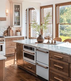 a kitchen with an oven, dishwasher and sink in it's center island