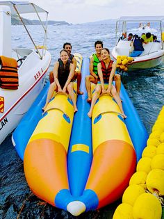 three people are sitting on an inflatable raft