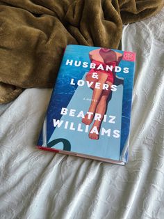 the book husbands and lovers by beatriz williams is laying on top of a bed