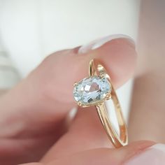 This ring has a minimal design, and you can wear it any day and combine it with other jewelry . It makes for an excellent gift for a loved one, without being extravagant. - Gold Kt: 9K, 14K and 18K Solid Gold - We can make all three Gold Colors: Rose Gold, Yellow Gold, White Gold - The band width is 1,8mm. - Oval Aquamarine : 1pc 7x5mm High Quality gemstone - Aquamarine Weight: 0,65ct - Aquamarine Color: light  ✔ Ready to Ship in 7-10 Business Days Each one of our items comes with a guarantee. T Aquamarine Meaning, Engagement Ring Aquamarine, Engagement Wishes, Blue Diamond Jewelry, Elegant Engagement Ring, Aquamarine Color, Ring Elegant, Aquamarine Colour, Elegant Engagement Rings