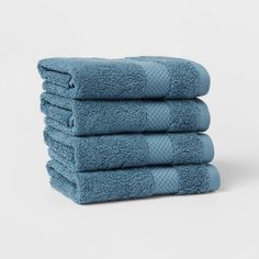 five blue towels stacked on top of each other