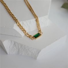 Classy with a touch of emerald. This necklace is perfect for the season giving you a subtle pop of color in your stack. Wear this alone or layer with others! This necklace is made of stainless steel, so waterproof! The color remains perfect. Gold: 18k gold platingMaterial: Stainless steelLength: 38cm + 5cm Waterproof Tarnish Free Hypoallergenic Glazd Pouch with every order Free US shipping Easy Exchange & Return policy PRODUCT INFOAll our jewelry are made of stainless steel material. For the gol Elegant Green Stainless Steel Necklace, Green Minimalist Tarnish-resistant Necklace, Everyday Green Chain Necklace, Green Minimalist Chain Necklace With Adjustable Chain, Green Chain Necklace With Adjustable Chain, Everyday Green Adjustable Chain Necklace, Stainless Steel Chain Necklace, Emerald Necklace, Gold Piece