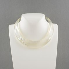 This is part of Chairish’s Costume Jewelry assortment.  An elegant Italian artisan designer studio collar choker necklace.  Lucite or resin rigid bib shape in translucent clear color ornate with silver flakes inclusions in an organic abstract free-form design. Silvered metal chain to adjust the length. No visible maker's mark. Measurements: The inner circumference is 16.57 in (42 cm) - the front height is 1 in (2.6 cm) - the opening is 3.38 in (8.5 cm) - the necklace will fit an average 14.57 in Modern Round Lucite Jewelry, Modern Handmade Clear Necklaces, Elegant Resin Necklaces For Party, Elegant Clear Resin Jewelry, Elegant Resin Jewelry For Wedding, Elegant White Resin Jewelry, Modern White Lucite Jewelry, Adjustable Elegant Resin Necklace, Elegant Lucite Jewelry For Formal Occasions