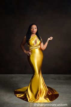 a woman in a gold dress posing for the camera with her hand on her hip