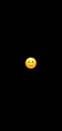 a yellow smiley face in the dark