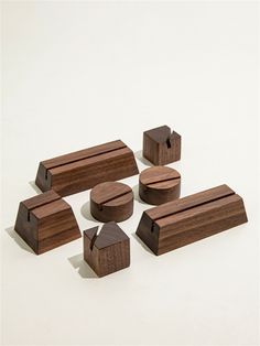 several pieces of wood sitting next to each other on a white surface with one piece missing