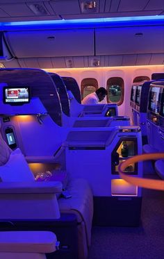 the inside of an airplane with purple lighting