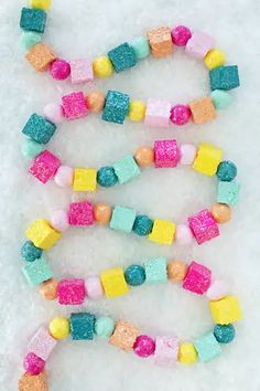 some candy beads are laying in the snow