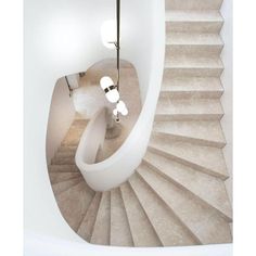 an overhead view of a spiral staircase in a house with white walls and flooring