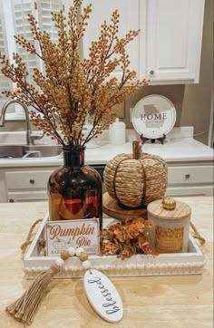 a table topped with bottles filled with different types of items next to a sign that says pumpkin spice