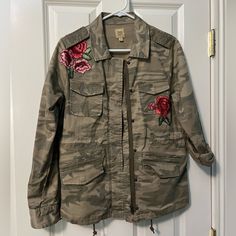 True Craft Camo Jacket With Embroidered Roses. Snaps And Zips Up And Has Draw String At Waist For A More Fitted Look. Never Worn. Has A Nice Feel To It And Very Stylish! Comes From A Smoke Free, Pet Friendly Home Fall Outerwear With Floral Applique And Long Sleeves, Casual Fall Outerwear With Floral Applique, Spring Outerwear With Floral Applique And Long Sleeve, Casual Floral Applique Outerwear For Fall, Pink Outerwear With Floral Embroidery For Fall, Fall Long Sleeve Outerwear With Floral Applique, Pink Floral Embroidered Outerwear For Fall, Spring Long Sleeve Outerwear With Floral Applique, Casual Pink Outerwear With Floral Embroidery