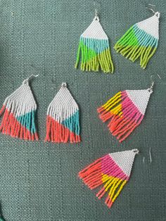 These are my classic seed bead chandelier earrings, but with a fun print. Handwoven seed beads at the top going out to a longer fringe at the bottom.  These beads are in cool colors with bright colors to make your outfit pop. Get compliments on dates, at festivals, the beach, and all those summer concerts! Three different variations offered so be sure to pick your favorite (or all three *handmade *custom and larger orders available upon request Summer Party Beaded Fringe Earrings, Fun Beaded Earrings For Summer, Fun Colorful Beaded Earrings For Summer, Multicolor Beaded Earrings For Spring Party, Multicolor Beaded Earrings For Summer Party, Summer Party Multicolor Beaded Earrings, Rainbow Beaded Earrings For Summer Festival, Multicolor Beaded Fringe Earrings For Party, Summer Rainbow Beaded Earrings