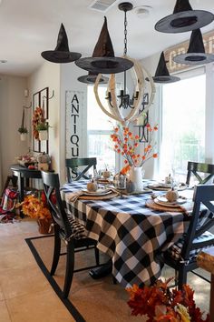 the dining room table is set with black and white checkered cloths on it