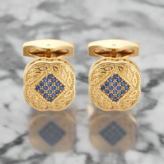 Gold Square Cufflinks with Blue Stones These gold square cufflinks with small blue stones combine elegance and subtle sophistication. The rich gold is beautifully offset by the delicate blue stones, making these cufflinks a versatile and refined addition to any formal or semi-formal ensemble. Dress Shirts: White Dress Shirt: A white dress shirt provides a classic and clean backdrop, allowing the gold and blue cufflinks to stand out. Light Blue Dress Shirt: The soft blue of the shirt complements Elegant Rectangular Cufflinks For Formal Occasions, Elegant Blue Cufflinks For Formal Occasions, Elegant Blue Cufflinks For Business, Classic Blue Cufflinks For Formal Occasions, Classic Blue Jewelry For Business, Elegant Blue Cufflinks For Gift, Light Blue Dress Shirt, Pale Pink Dress, Navy Blue Suit