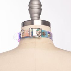 Classic choker collar in iridescent, holographic vinyl layered over PVC. An aurora borealis chandelier crystal point adorns the center o-ring. Fit is adjustable with buckle. Holes are reinforced with grommets.Collar is 3/4" wide, with a 2" crystal point.SMALL/MEDIUM (11-13")MEDIUM/LARGE (13-15")LARGE/X-LARGE (15-17")Custom sizing available.  All pieces are MADE TO ORDER, standard sizes S/M-L/XL.  If your measurements fall outside these standards or you are unsure of what size to order, select "C Fall Outside, Derby Outfits, Chandelier Crystal, Holographic Vinyl, Roller Derby, Choker Collar, Ring Fit, Rave Outfits, Crystal Points