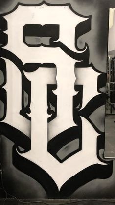 a black and white photo of the detroit tigers logo painted on a wall in an industrial area