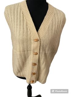 Gorgeous beautifully made hand knit vest with wood toggle buttons and grosgrain trim inside. Unisex, I believe meant for a man, but would fit women's large great. 20" pit to pit. See photos, please note small moth hole front bottom right that is not noticeable really. Fall Beige Sweater Vest With Buttons, Knit Sweater Vest With Buttons For Fall, Knit Button Sweater Vest For Fall, Vintage Beige Sweater Vest For Fall, Wool Sweater Vest With Buttons For Fall, Casual Wool Vest With Buttons, Vintage Button Sweater Vest For Winter, Beige Buttoned Sweater Vest Casual, Casual Beige Sweater Vest With Buttons