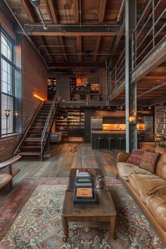 a living room filled with lots of furniture and a fire place next to a stair case