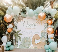 an outdoor baby shower is decorated with balloons and pastel blue, orange and white colors