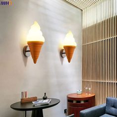 two ice cream cones are on the wall next to a chair and table in a room