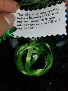 someone is holding a christmas ornament with a note attached to it that says, this ribbon is very special