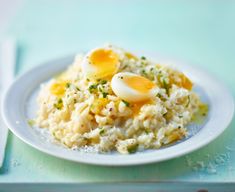 a white plate topped with rice and an egg