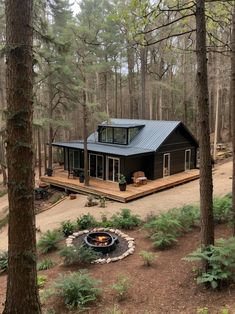 a cabin in the woods with a fire pit