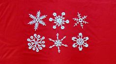 four snowflakes are shown on a red background