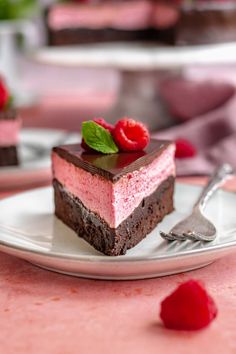 a piece of cake on a plate with raspberries