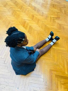 a woman sitting on the floor with her legs crossed