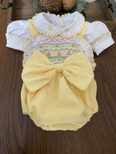 Pre-order handmade smocked romper. It takes 4-6 weeks to ship. Thank you for your patience. Thank you for supporting a small business. Clothing Care Instructions Most items can be washed safely in cold water on delicate cycle and hung to dry. If the item that you are ordering has red or another bright color in it next to a white or other light color fabric please use a Shout color catcher for the first few washes to avoid bleeding. The reds are pre-washed but they are still red and will likely h Cotton Fitted Bubble Romper With Smocked Back, Spring Bubble Romper With Smock Detail, Spring Cotton Bubble Romper With Smocked Cuffs, Spring Fitted Smocked Bubble Romper, Spring Fitted Smock Bubble Romper, Cute Cotton Bubble Romper With Smocked Bodice, Fitted Smock Bubble Romper For Summer, Spring Bubble Romper With Smock For Playtime, Spring Smock Bubble Romper For Playtime