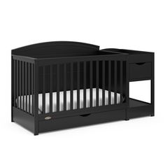 a black crib with two drawers on the bottom