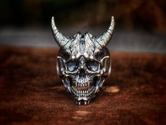 sterling silver inferno demon skull ring, birthday gift, Christmas gift, storyteller. About 33 grams in weight, 4.1 cm from the chin to the tips of horns, 3.4 cm from the chin to the top of head. All ring sizes are possible to order. Please don't hesitate to send me a message if your ring size is not in the regular size chart! "From the Abyss" series, FTA-R008; Ninety Thousand Killer-Ogres Alpha type.  They are led by Thunder Blast~~The Lord of the second Abyss Asura. With their outstanding mili Halloween Engraved Skull Ring Gift, Handmade Unique Skull Ring For Halloween, Handmade Skull Ring As Gift, Handmade Skull Ring Gift, Handmade Skull Ring For Gift, Handmade Silver Skull Ring For Halloween, Demon Skull, Tree Pattern, Lost Wax Casting