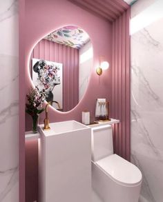 a white toilet sitting next to a pink wall in a bathroom under a round mirror