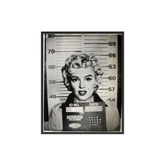 marilyn monroe mug shot in black and white with police numbers on the front, behind her is a jail cell