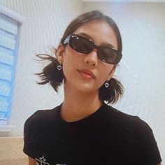 a woman wearing sunglasses is looking at the camera