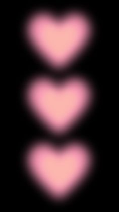 three pink hearts on a black background with no image to describe, it looks like they are floating in the air