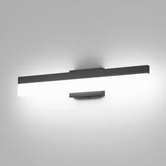 an image of a bathroom light that is on the wall in black and white photo