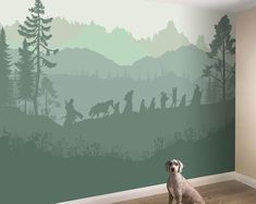 a dog sitting on the floor in front of a wall mural